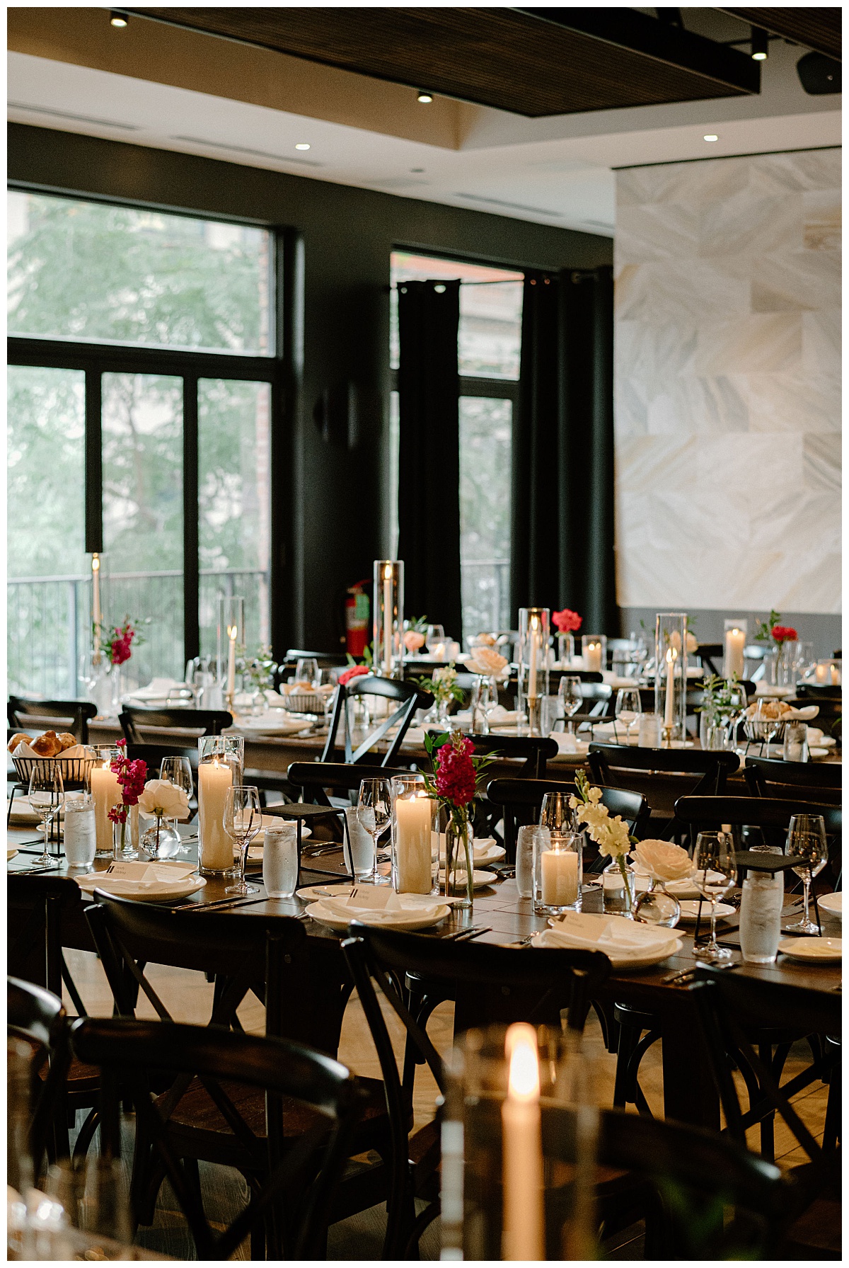 reception tables are all lined up with candles and summer florals by Indigo Lace Collective