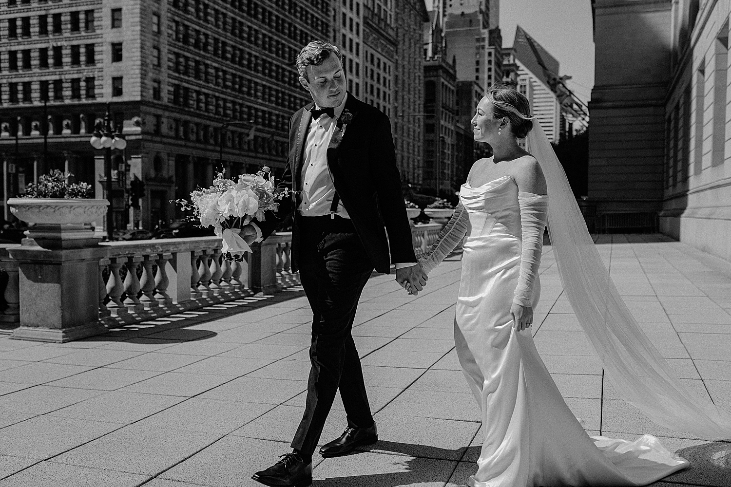 man and woman walk hand in hand across the street by Morgan McIntire Photography