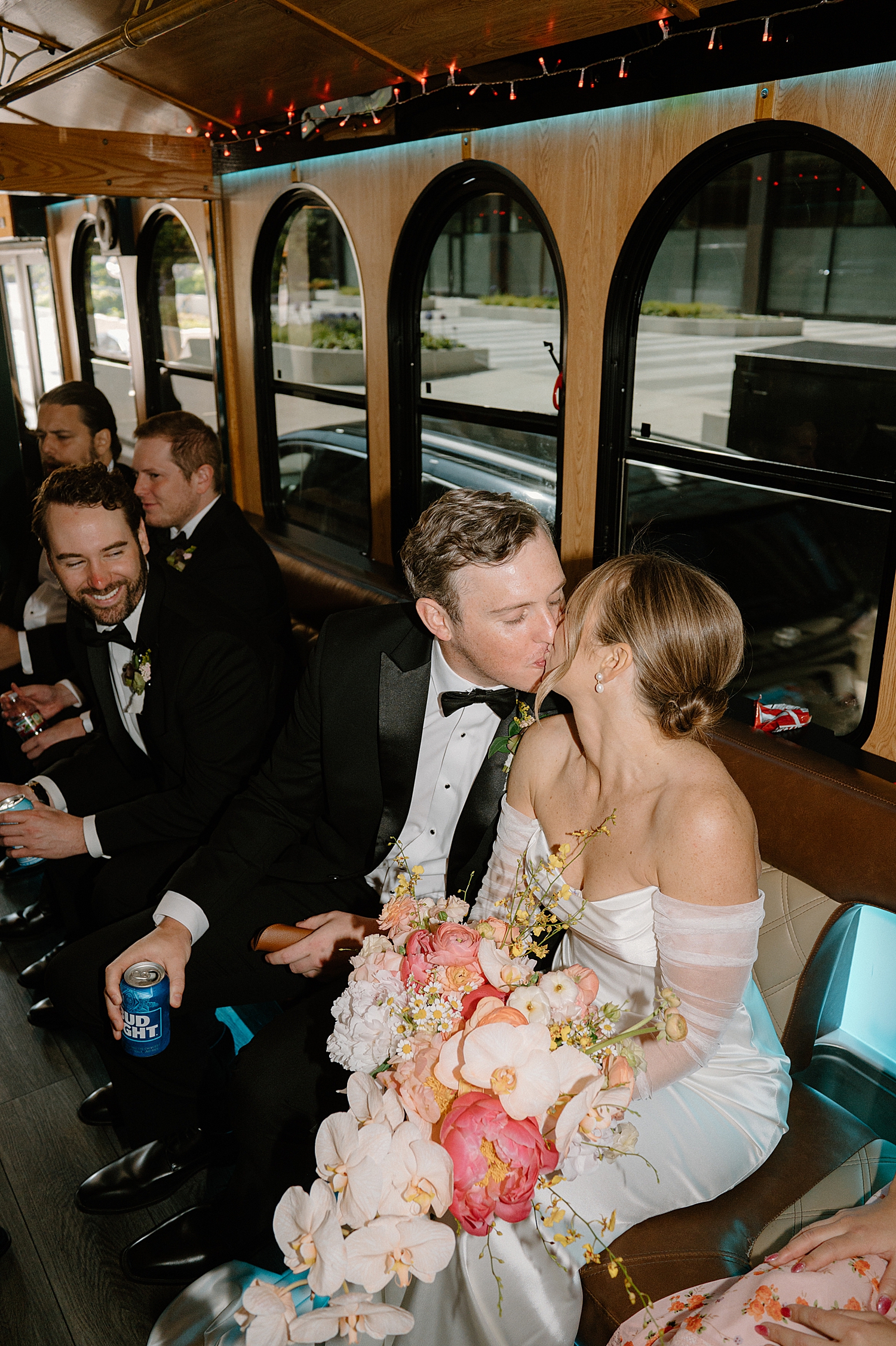 couple shares a kiss in party bus by Chicago wedding photographer