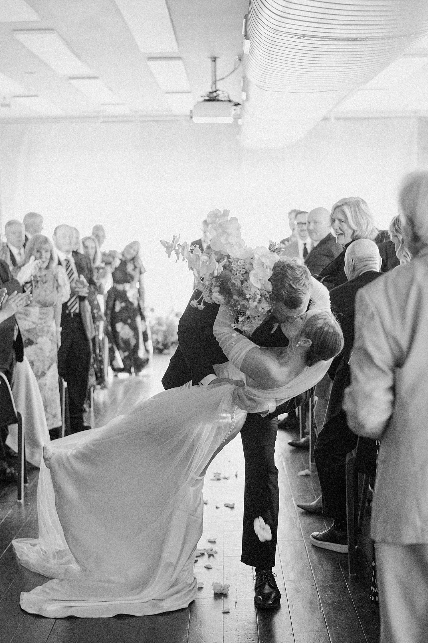 man dips woman for kiss after ceremony by Morgan McIntire Photography