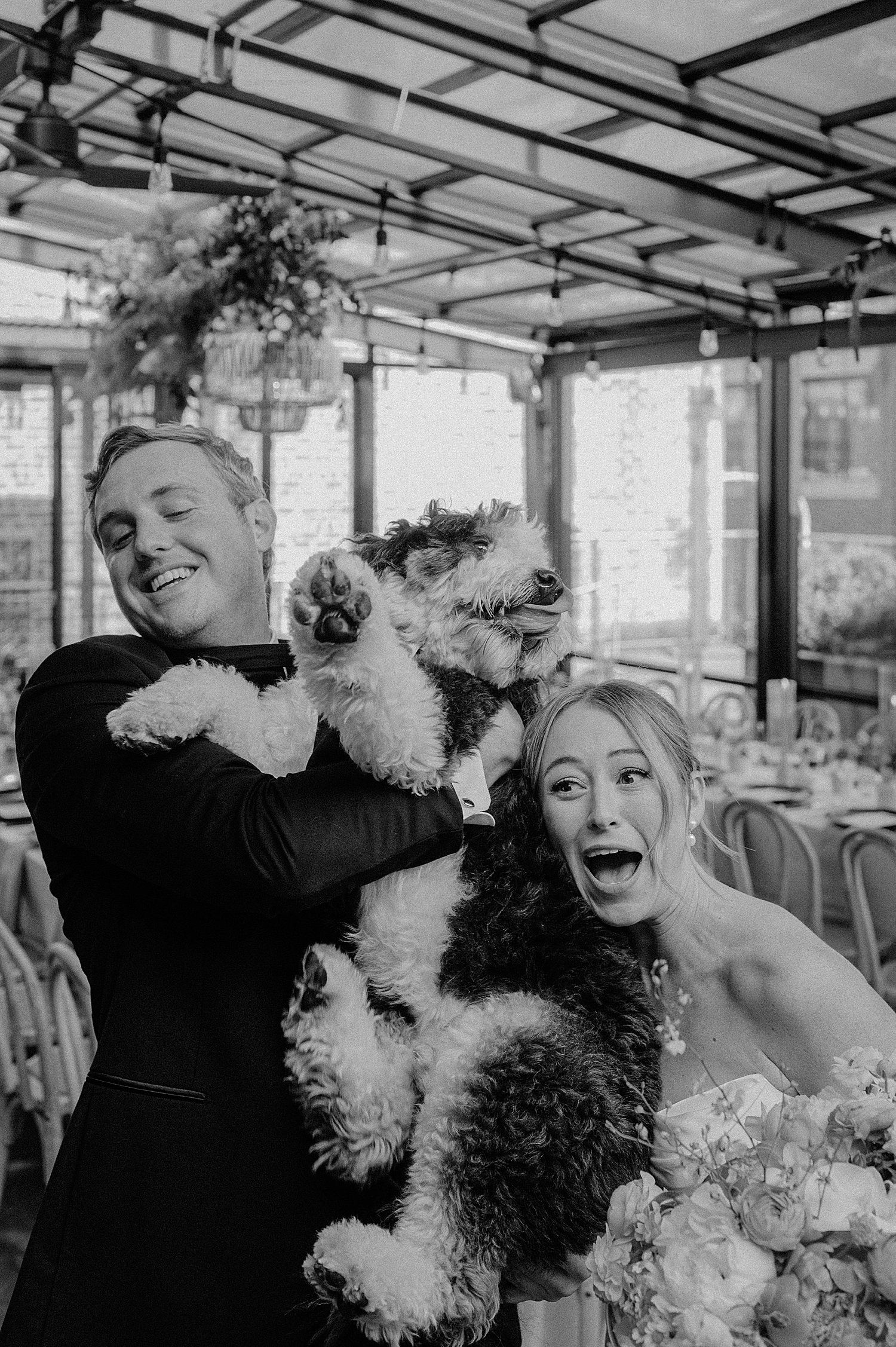 woman and man snuggle their dog after ceremony by Morgan McIntire Photography