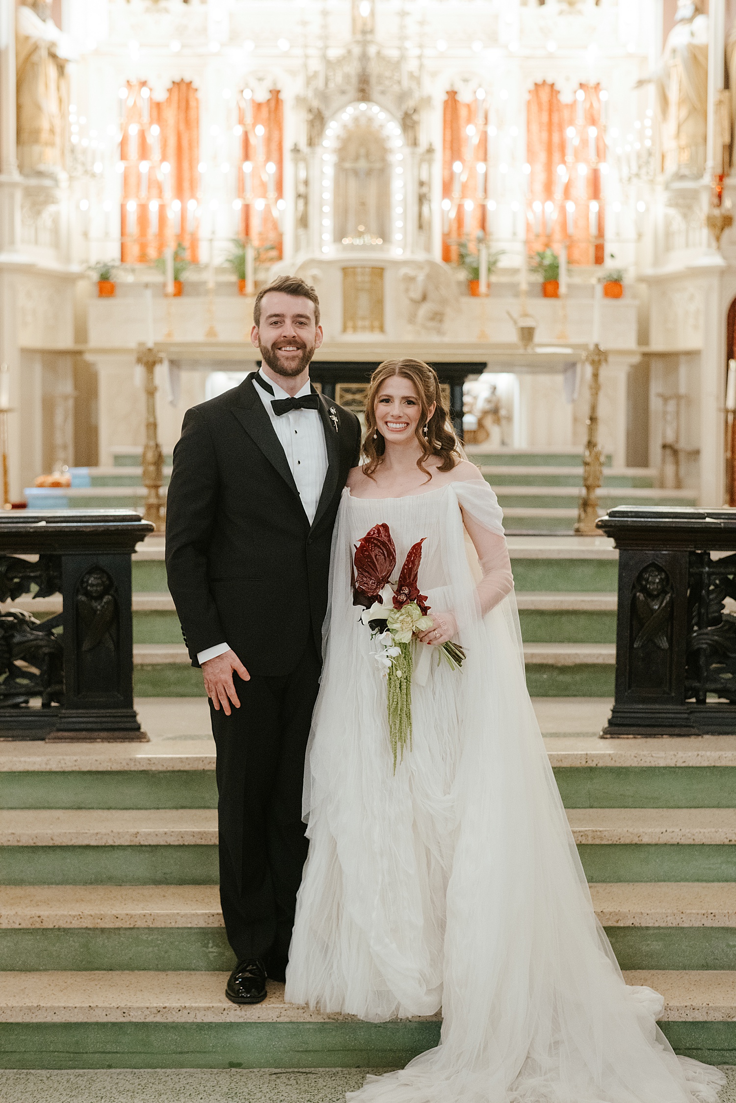 newlyweds stand in front of alter by Chicago wedding photographer