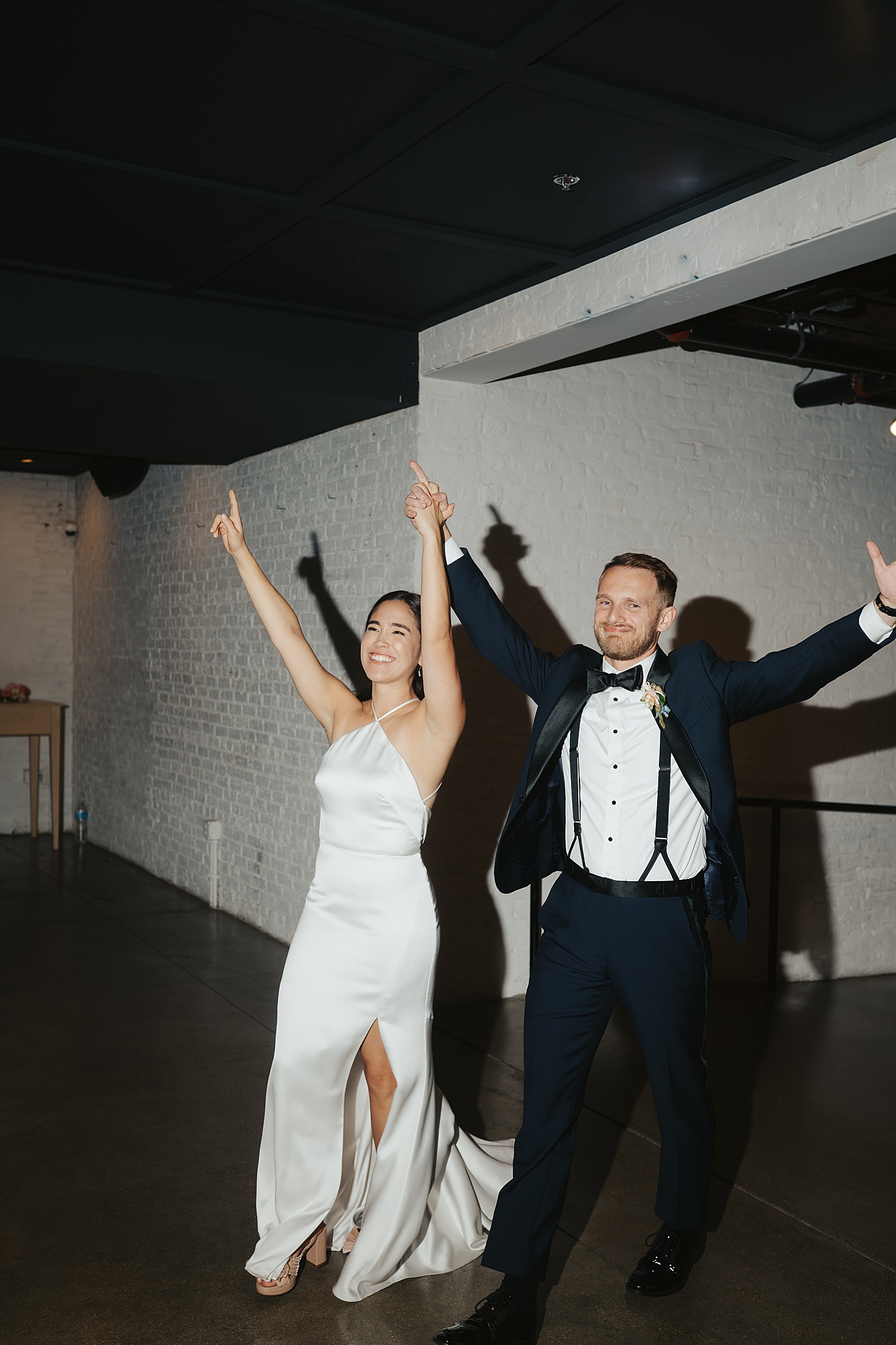 husband and wife re-enter reception after taking golden hour photos by Morgan McIntire Photography