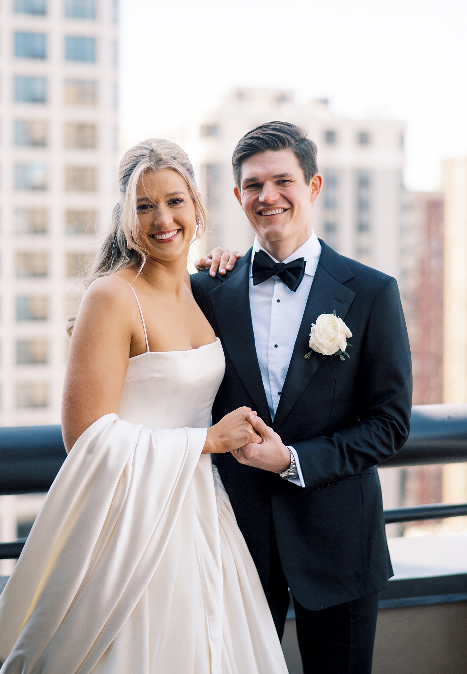newlyweds stand on balcony at Lincoln Park