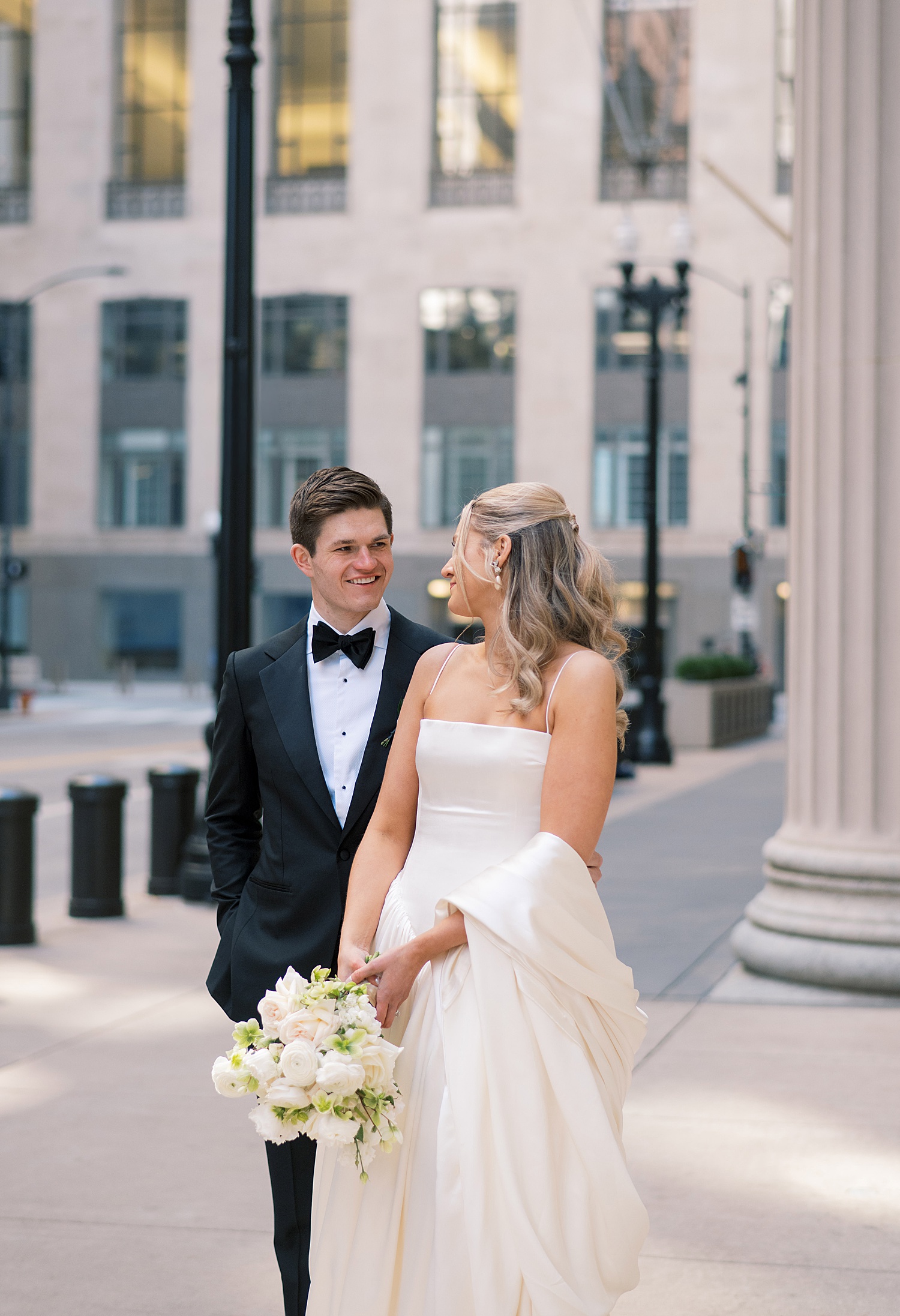 couple stand on sidewalk by Chicago wedding photographer