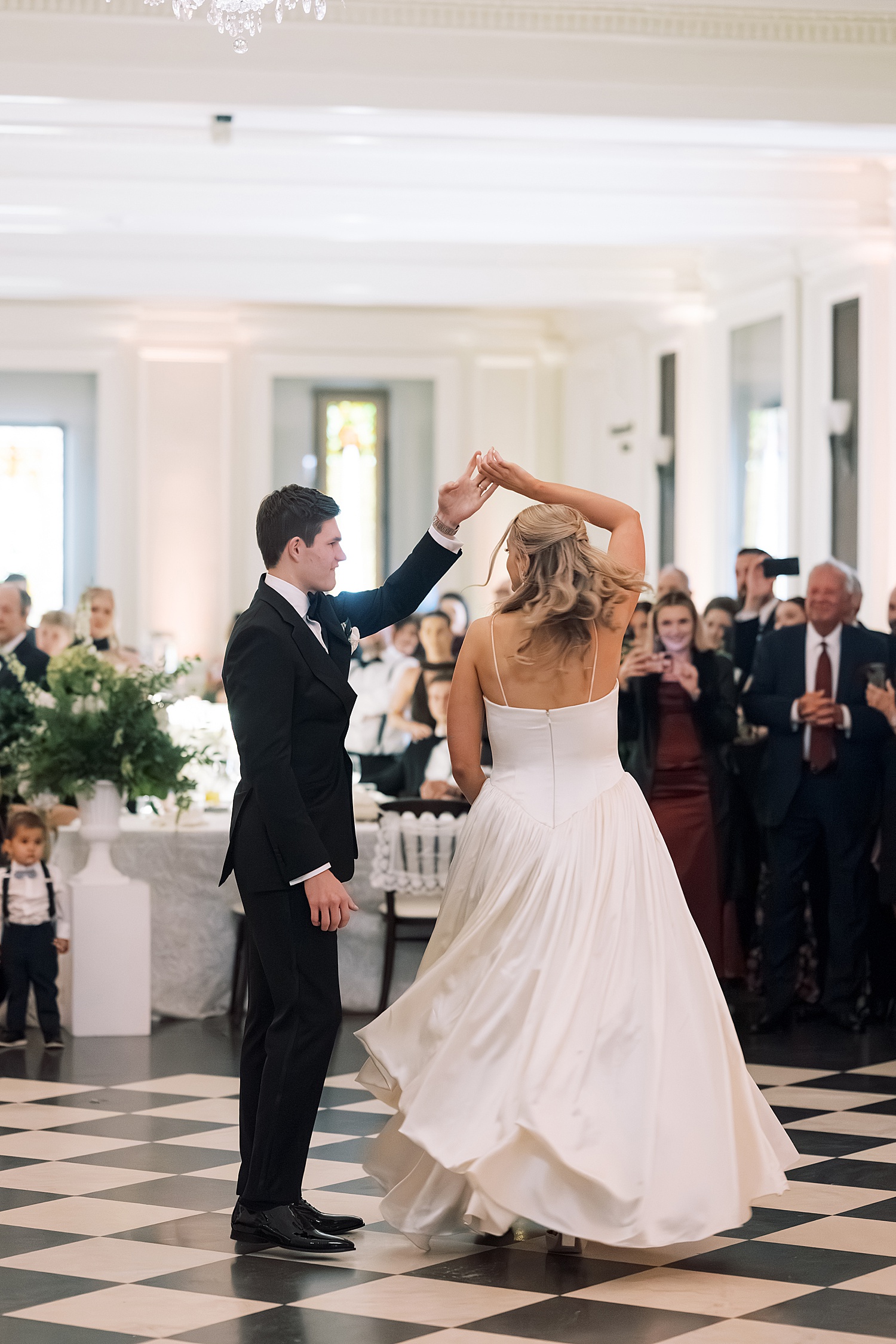 groom twirls bride on dance floor at Lincoln Park