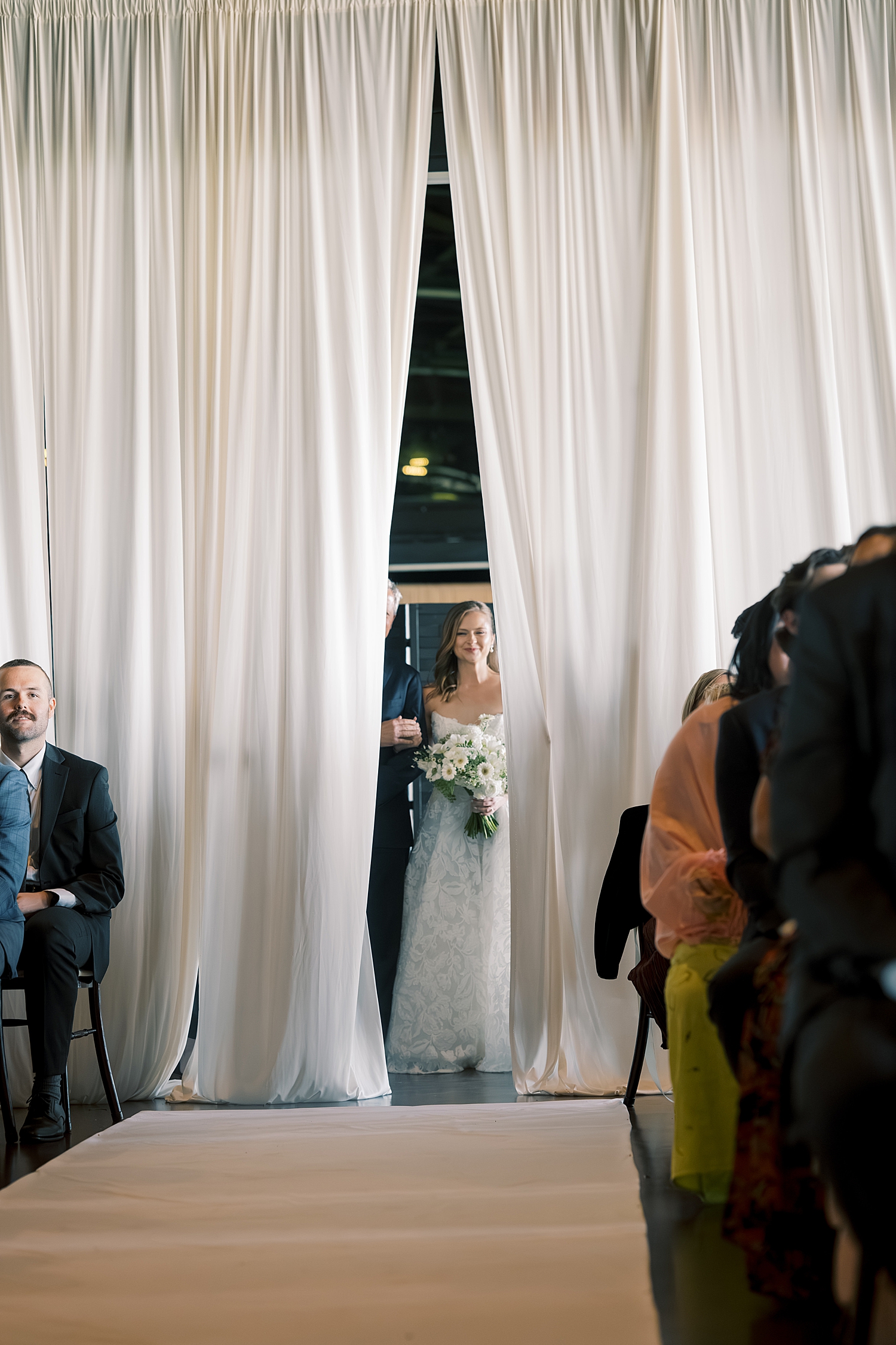 curtains peel back to reveal bride ready to walk down the aisle by Morgan McIntire Photography
